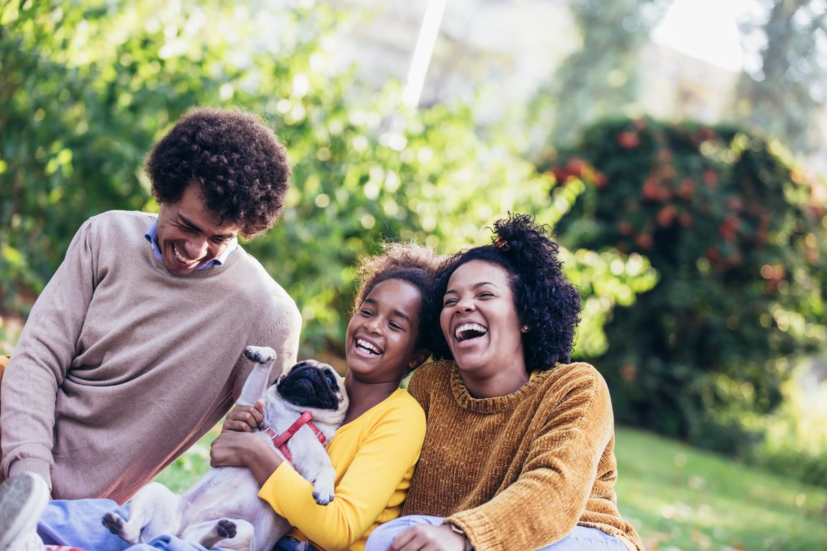 Happy family enjoying time with their dog